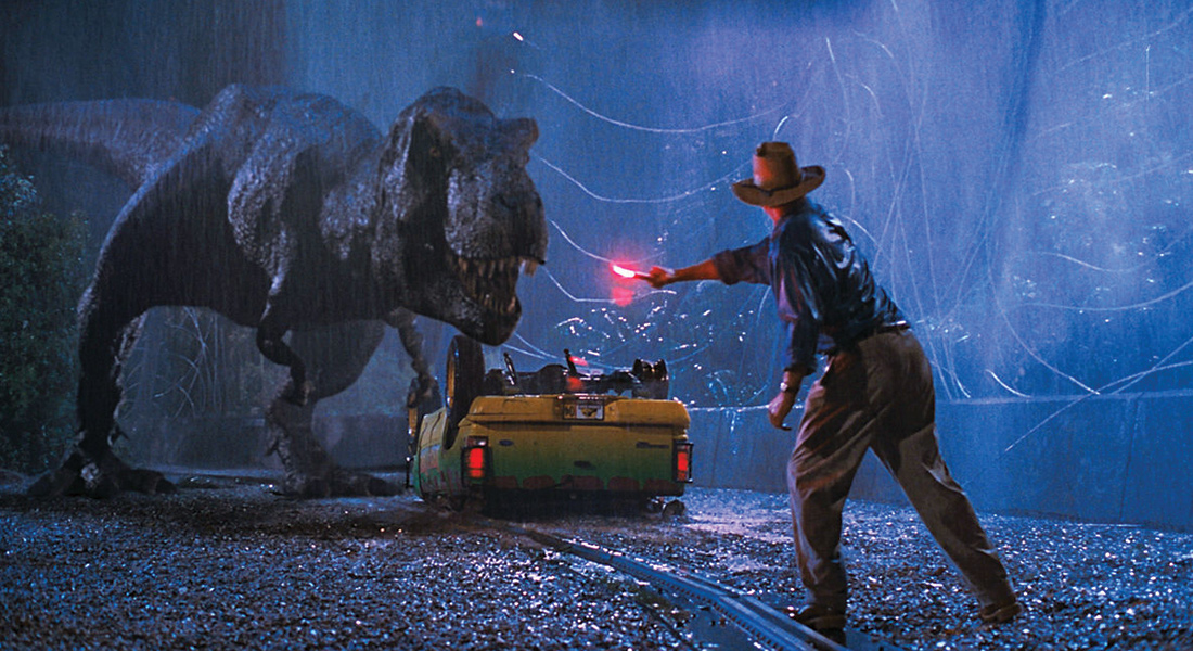 Still image from Jurassic Park featuring Grant and a T-Rex.