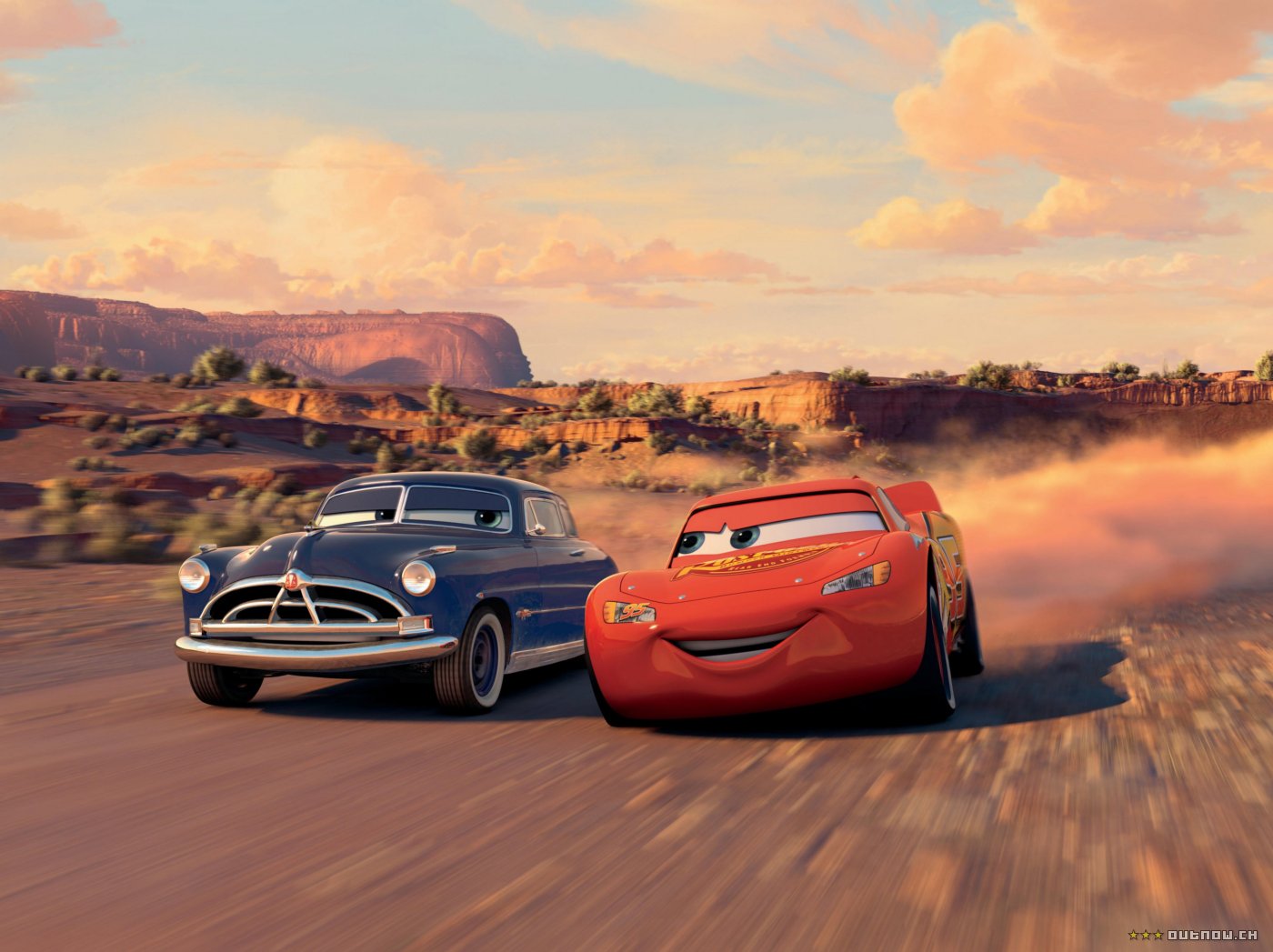 image from Pixar's Cars with Lightening McQueen driving dow a dirt road.